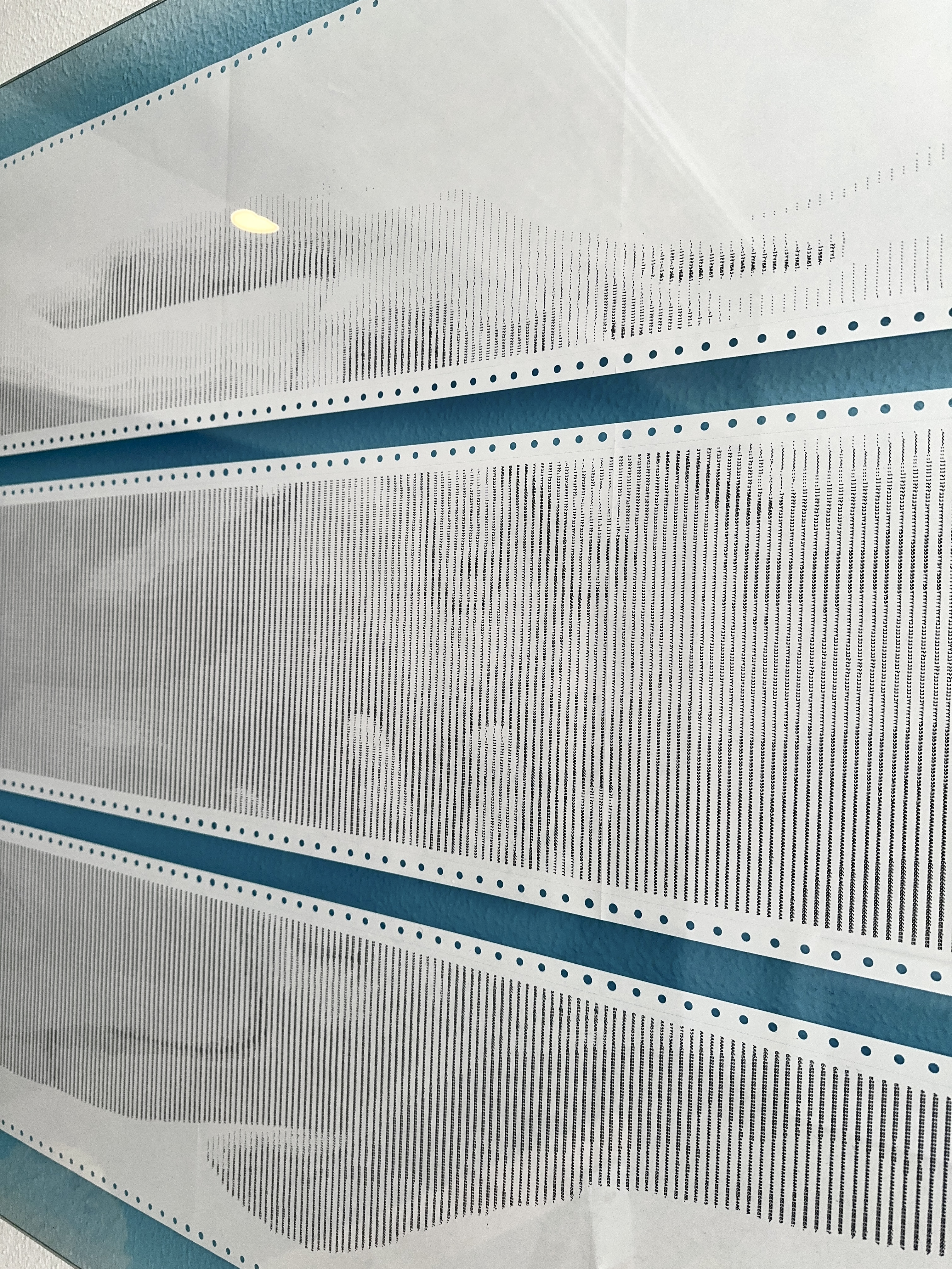 Close-up detail of BODY.QUEUE by CHARACTERS highlighting the printed surface, paper texture, and coded figure.